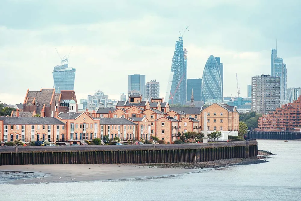 View of London Docklands with the Thames River, downtown, cucumber and city center. Real estate buildings suburbs