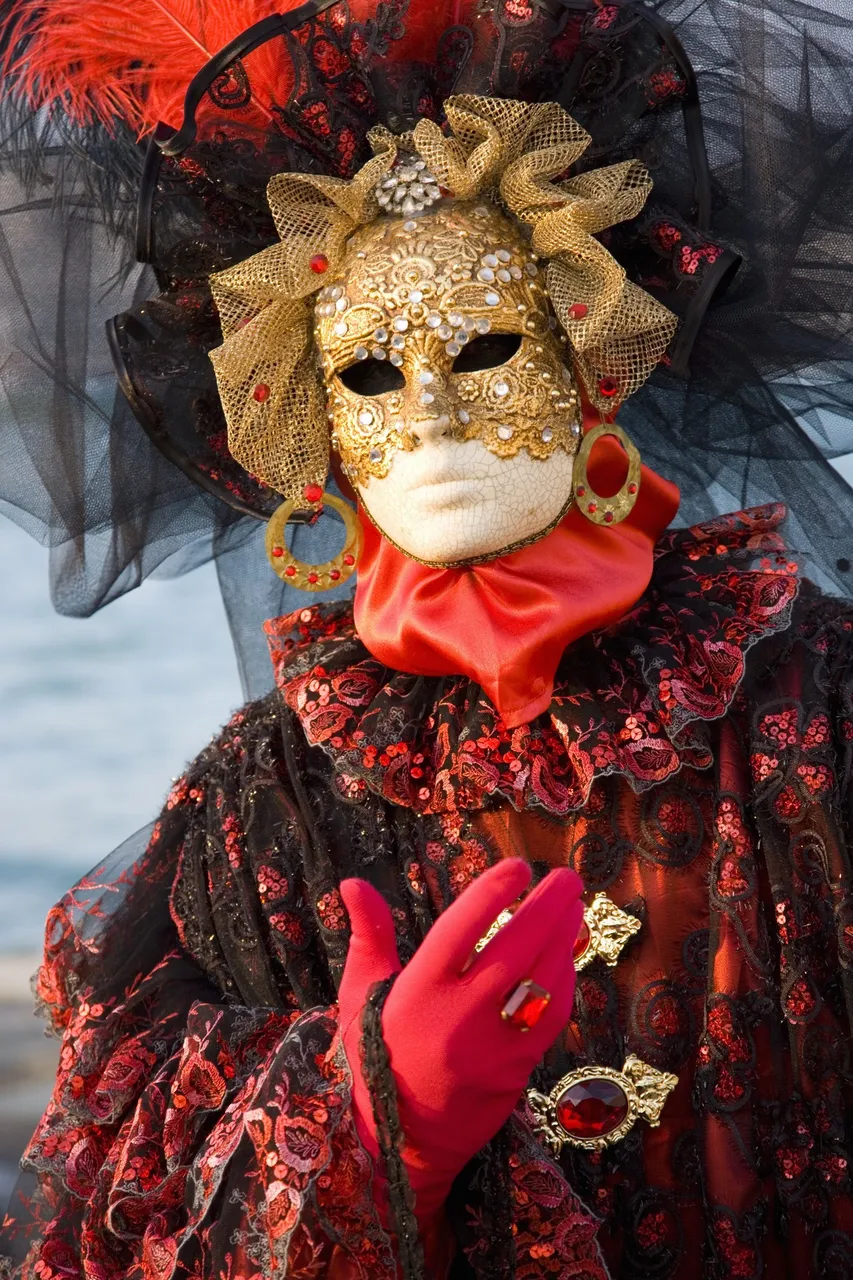 A sophisticated figure in an ornate costume and mask, adorned with luxurious details, posing elegantly at the prestigious Il Ballo del Doge event