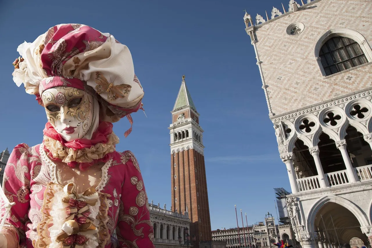 A single person in an opulent Venetian carnival costume and mask, standing in the center of a grand plaza.