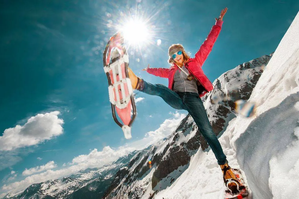 Austria, Salzburg County, Young woman snowshoeing in the mountains