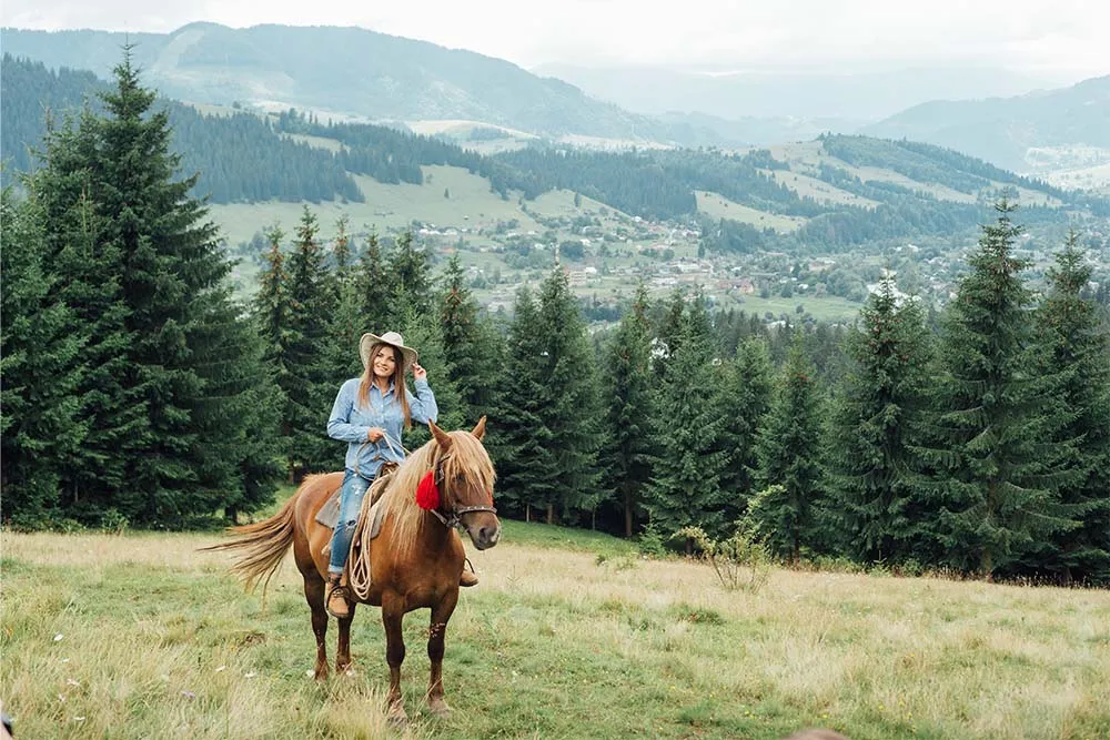 Woman on horseback in the mountains in Montana — Shutterstock
