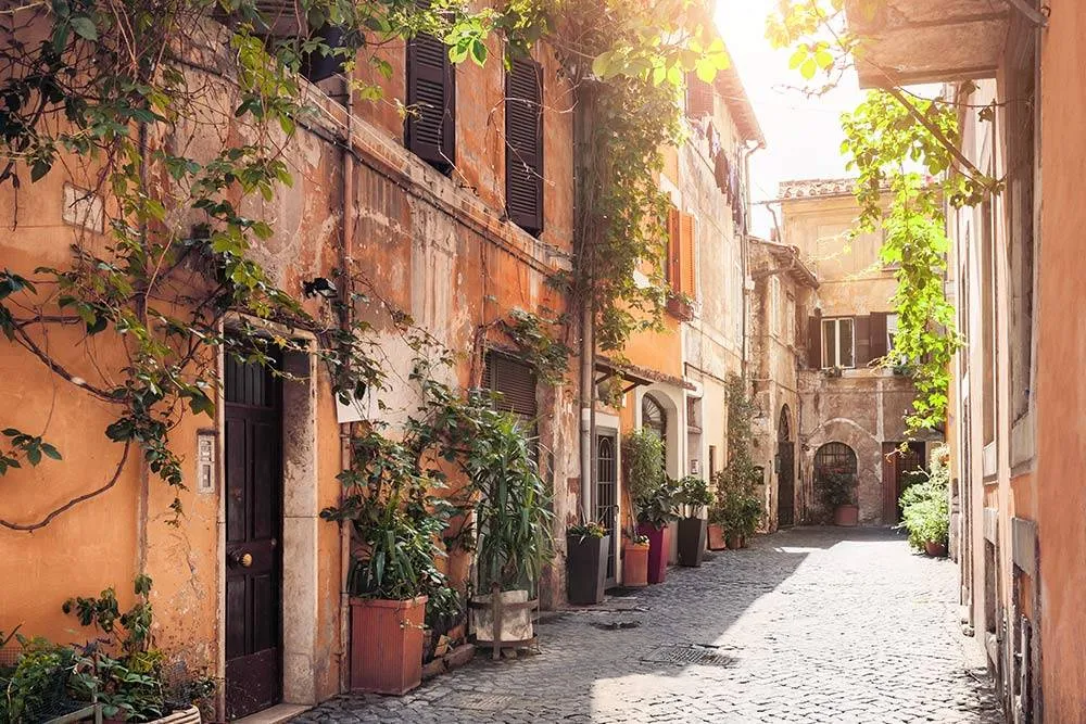 The historic Trastevere district in Rome, Italy is full of cobbled streets with terra-cotta colored houses