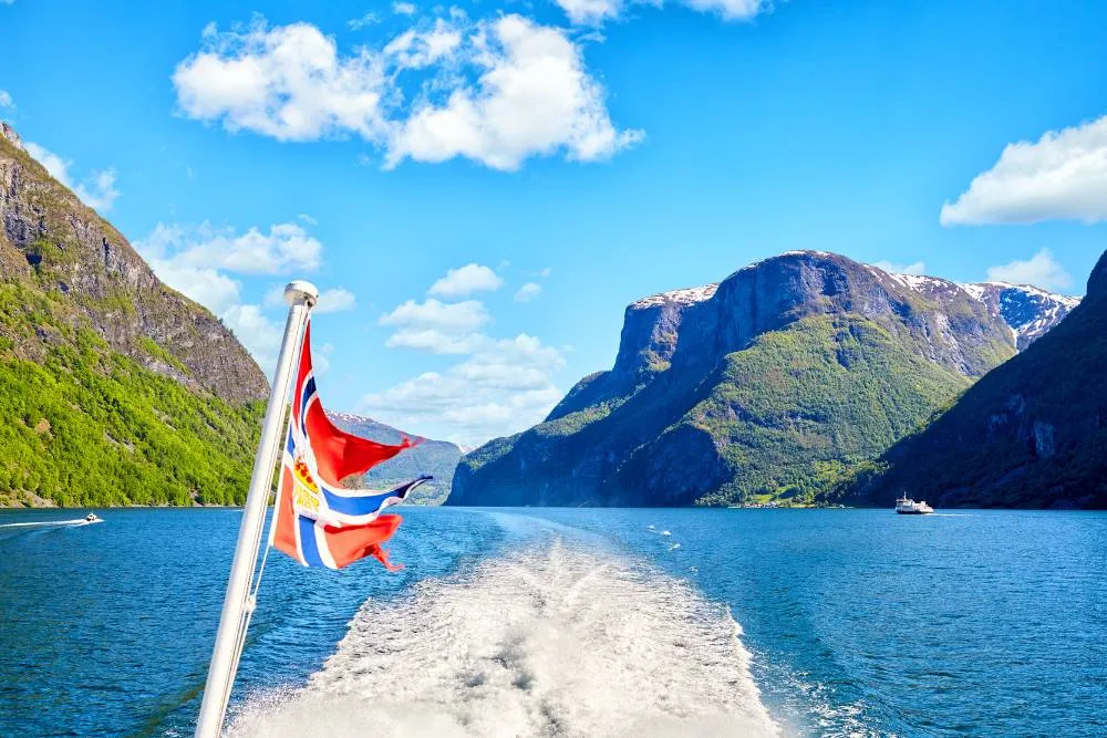 Norwegian flag on ferry ship in Sognefjord — Getty Images