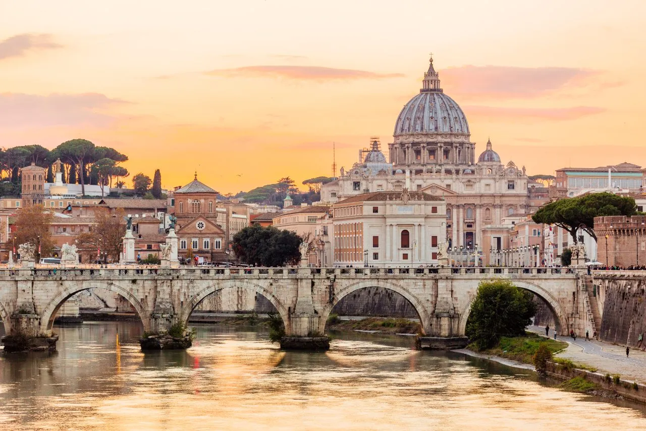 Rome skyline at sunset with Tiber river and St. Peter’s Basilica, Italy