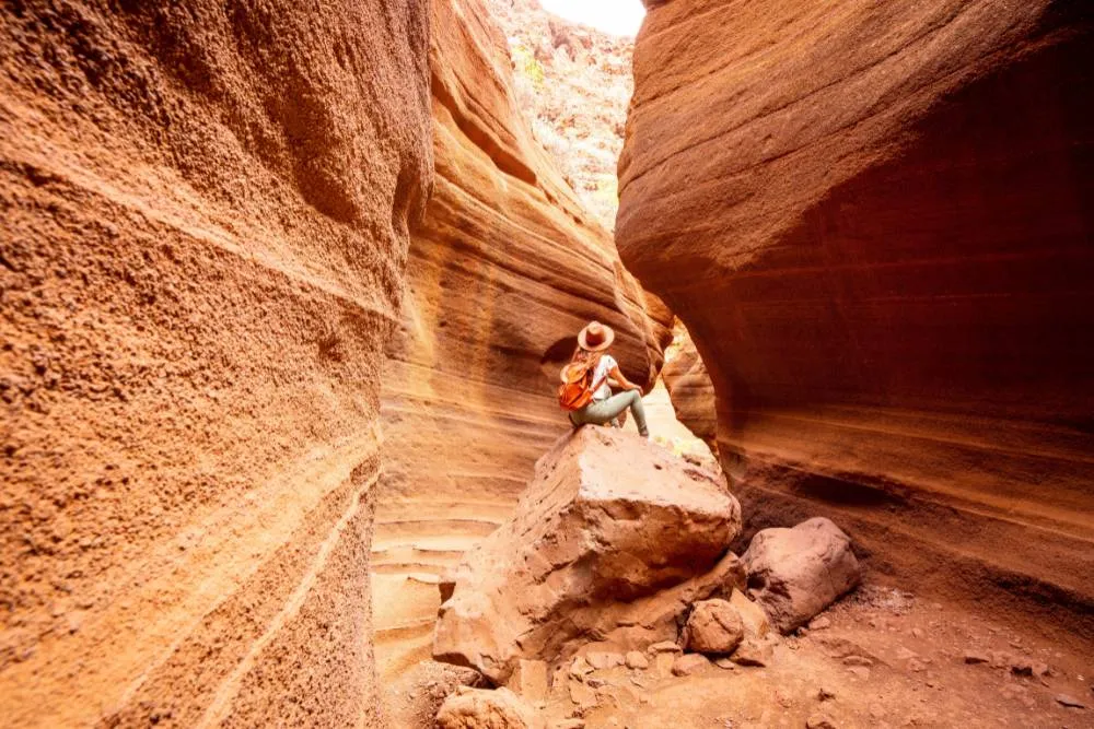 Woman sitting in canyon in Gran Canaria — Getty Images