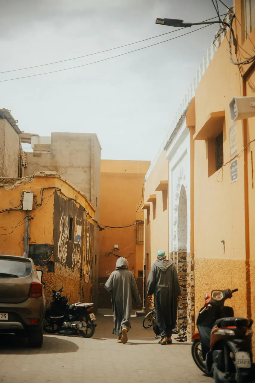 Locals walking through the narrow alleys of Fes