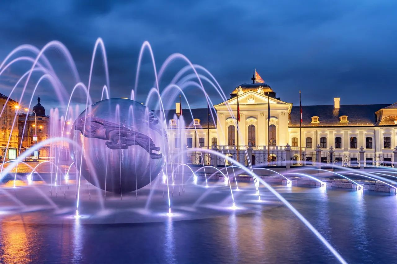 Illuminated fountain in front of the Presidential Palace (Grassalkovich Palace) in Bratislava at dusk