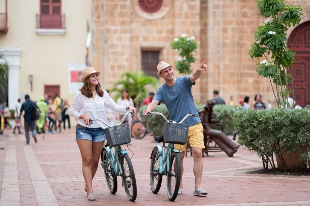 Two tourists walking with bikes in Cartagena — iStock