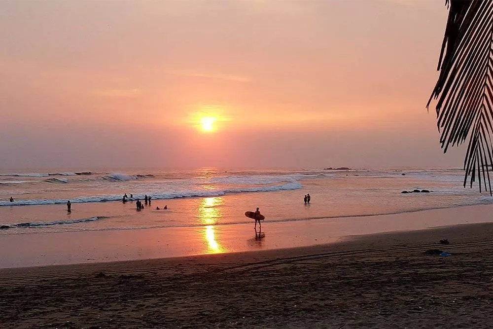 Surfers on the beach in Nicaragua at sunset — Shutterstock