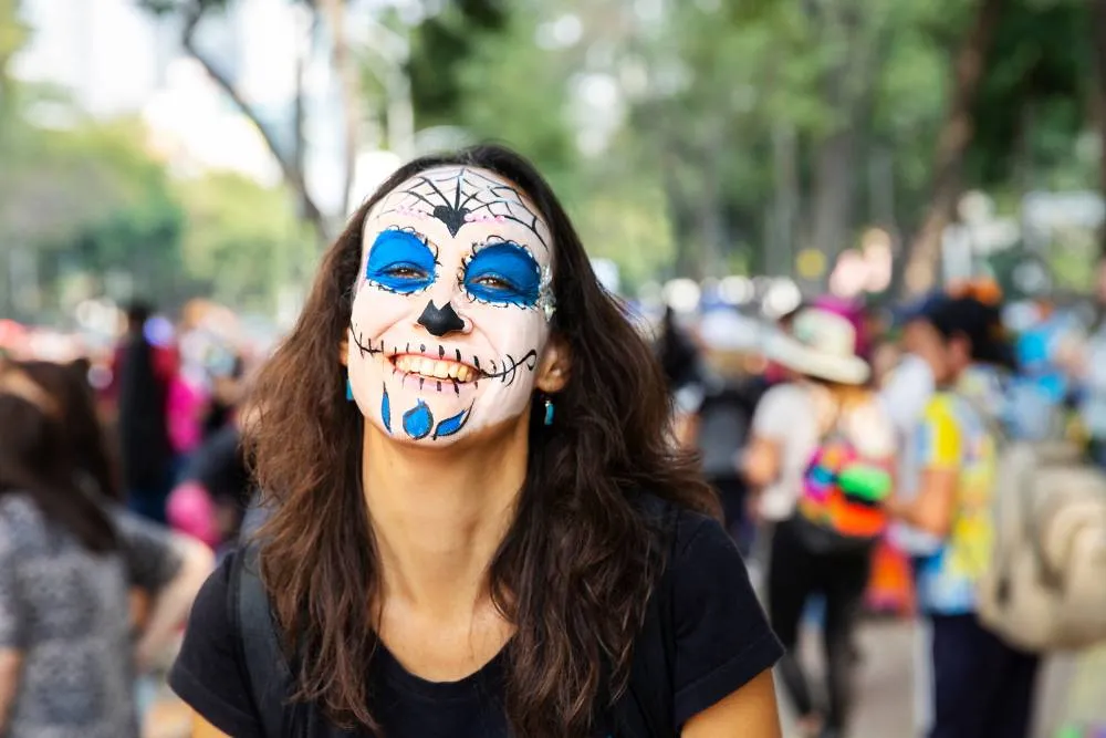 Woman with painted face at Day of the Dead parade — Getty Images