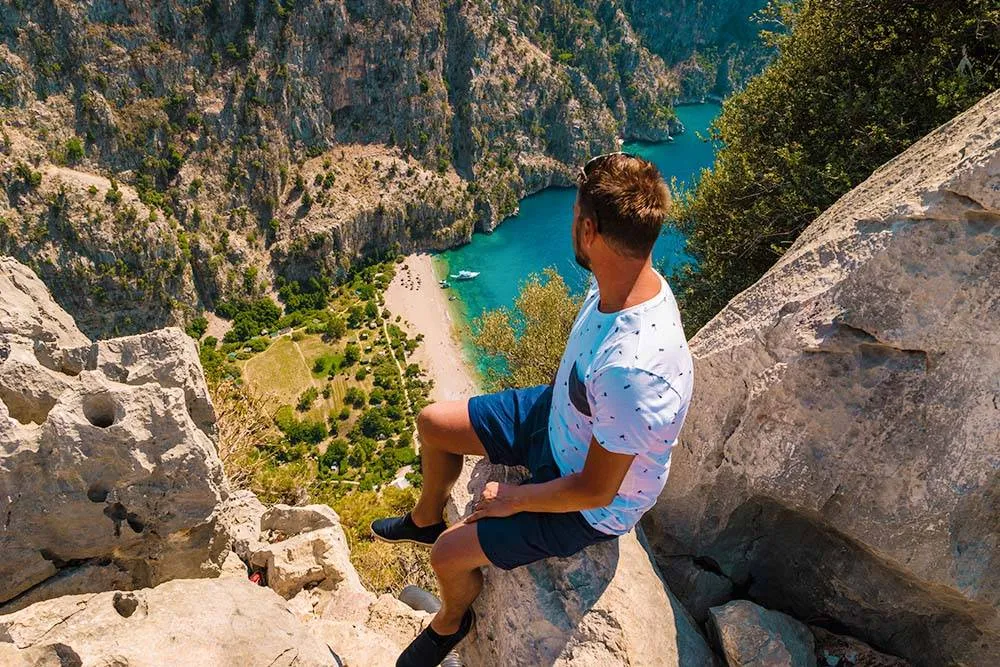 cliff in the mountain watching butterfly beach from the top at the ocean of Fethiye turkey