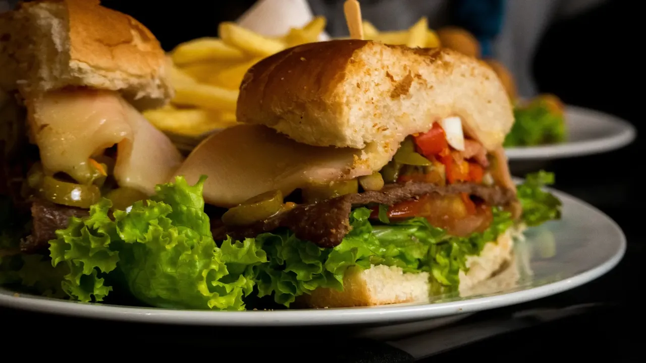 Chivito is an Uruguayan traditional sandwich filled with sliced steak, ham, cheese and mayonnaise — Shutterstock