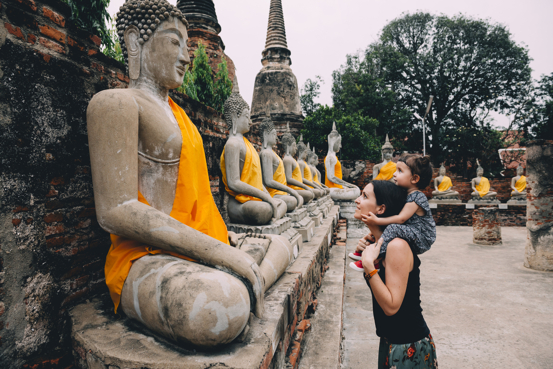 Mother with her baby girl admiring Buddha statues, Wat Yai Chai Mongkhon, Bangkok